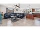 Open-concept living room with tile floors, ceiling fan, and stylish sectional sofa at 8517 43Rd W Ave, Bradenton, FL 34209
