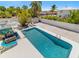 Aerial view of the backyard swimming pool with lounging area, lush landscaping, and privacy fence at 8517 43Rd W Ave, Bradenton, FL 34209