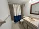 Bathroom featuring a shower-tub combo, linoleum flooring, and single sink vanity at 8550 Shadblow Ct # 2, Port Richey, FL 34668