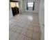 Bedroom with tile floors and window with curtains, offers a bright and airy space at 8550 Shadblow Ct # 2, Port Richey, FL 34668