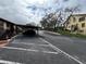 Exterior showcasing covered parking and mature trees near the condo building at 8550 Shadblow Ct # 2, Port Richey, FL 34668