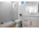 Bathroom featuring glass shower, toilet, white vanity with quartz countertop, and wood look flooring at 870 N Osceola Ave, Clearwater, FL 33755