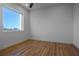 Bedroom with laminate wood flooring, baseboard trim, fan, and a large window at 870 N Osceola Ave, Clearwater, FL 33755
