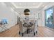 This dining area features light wood flooring, stylish seating for four and an adjoining modern kitchen at 870 N Osceola Ave, Clearwater, FL 33755