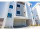 Modern three-story condo exterior featuring a private garage and decorative accents at 870 N Osceola Ave, Clearwater, FL 33755