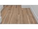 Close up of laminate flooring with light-colored wood grain at 870 N Osceola Ave, Clearwater, FL 33755