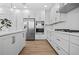 This modern kitchen features white cabinetry, stainless steel appliances, and an abundance of countertop space at 870 N Osceola Ave, Clearwater, FL 33755