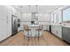 This modern kitchen features white cabinets, stainless steel appliances, and a large island with bar seating at 870 N Osceola Ave, Clearwater, FL 33755