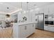 This modern kitchen offers stainless appliances, white countertops and cabinets, and seamless integration with the dining area at 870 N Osceola Ave, Clearwater, FL 33755