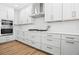 This modern kitchen has white cabinets, stainless steel appliances, and plenty of counter space for food preparation at 870 N Osceola Ave, Clearwater, FL 33755
