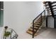 Modern staircase with wood treads, black metal railings, and stylish decor at 870 N Osceola Ave, Clearwater, FL 33755