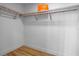 Walk-in closet featuring wooden shelving, laminate floors, and white walls at 870 N Osceola Ave, Clearwater, FL 33755