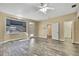 Bedroom featuring hardwood-style flooring, ceiling fan, a bay window, walk-in closet and exterior access at 9019 Long Lake Ave, Weeki Wachee, FL 34613