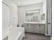 This bathroom features a large mirror, double sink vanity, bathtub, and toilet at 915 Brittany Park Blvd, Tarpon Springs, FL 34689