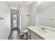 Bright bathroom featuring a sink vanity with modern fixtures, toilet, and shower at 915 Brittany Park Blvd, Tarpon Springs, FL 34689