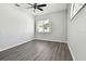 Light-filled bedroom with hardwood floors and large windows at 915 Brittany Park Blvd, Tarpon Springs, FL 34689