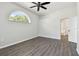 Bright bedroom featuring hardwood floors and an arched window with natural light at 915 Brittany Park Blvd, Tarpon Springs, FL 34689