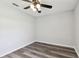 A calming bedroom with a lighted ceiling fan and gray vinyl flooring at 915 Brittany Park Blvd, Tarpon Springs, FL 34689