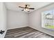 Bright bedroom featuring wood floors, a ceiling fan, and a view of the outside at 915 Brittany Park Blvd, Tarpon Springs, FL 34689