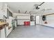 Garage featuring epoxy floor, updated lighting, and garage door opener at 915 Brittany Park Blvd, Tarpon Springs, FL 34689