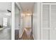 Neutral hallway featuring wood floors and doors that lead into multiple rooms at 915 Brittany Park Blvd, Tarpon Springs, FL 34689
