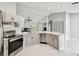 Bright kitchen with stainless steel appliances, white cabinets, and granite countertops at 915 Brittany Park Blvd, Tarpon Springs, FL 34689
