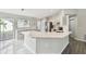 Open-concept kitchen with granite countertops, island, and stainless steel appliances at 915 Brittany Park Blvd, Tarpon Springs, FL 34689