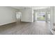 Spacious living room with hardwood floors and a view to the backyard patio at 915 Brittany Park Blvd, Tarpon Springs, FL 34689