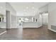 Spacious living room with hardwood floors that opens to the kitchen at 915 Brittany Park Blvd, Tarpon Springs, FL 34689