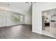 Spacious living room featuring hardwood floors, modern lighting, and a large window at 915 Brittany Park Blvd, Tarpon Springs, FL 34689