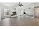 Open-concept living room with wood floors, fireplace, and mirrored wall at 915 Brittany Park Blvd, Tarpon Springs, FL 34689