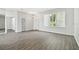Neutral living area showcasing wood floors and ample natural light at 915 Brittany Park Blvd, Tarpon Springs, FL 34689