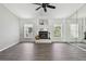 Inviting living room with wood flooring, fireplace, and natural light from windows at 915 Brittany Park Blvd, Tarpon Springs, FL 34689