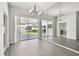 Bright living room with hardwood floors, sliding doors, and mirrored wall at 915 Brittany Park Blvd, Tarpon Springs, FL 34689