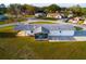 Aerial shot of the rear exterior showing its porch, carport and expansive lawn at 9170 Dupont Ave, Spring Hill, FL 34608