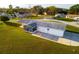 Aerial view of home with a large yard, screened patio, and convenient carport at 9170 Dupont Ave, Spring Hill, FL 34608