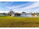 Expansive backyard featuring a home with a screened patio and ample green space at 9170 Dupont Ave, Spring Hill, FL 34608