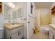 Bathroom featuring a vanity, mirror, and a separate shower/tub combination with yellow tile at 9170 Dupont Ave, Spring Hill, FL 34608
