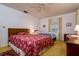 Spacious bedroom featuring two beds, a ceiling fan, and natural light from the window at 9170 Dupont Ave, Spring Hill, FL 34608