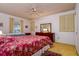 Bright bedroom showcasing two beds, a ceiling fan, and a large dresser at 9170 Dupont Ave, Spring Hill, FL 34608