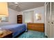 Charming bedroom featuring a blue bed, wooden dresser, and ample closet space at 9170 Dupont Ave, Spring Hill, FL 34608