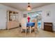 Cozy dining area featuring a table set for three and view to backyard at 9170 Dupont Ave, Spring Hill, FL 34608