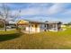 Low angle shot of the rear exterior featuring a screened in porch and covered patio at 9170 Dupont Ave, Spring Hill, FL 34608