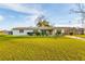 Charming one story home with white exterior, awnings, and large front yard at 9170 Dupont Ave, Spring Hill, FL 34608