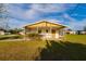 Exterior shot showing the home's carport and screened in porch at 9170 Dupont Ave, Spring Hill, FL 34608