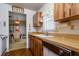 Kitchen with wood cabinets and view to the dining room in an open layout at 9170 Dupont Ave, Spring Hill, FL 34608