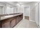 Bathroom featuring double sinks with granite countertops, a large mirror, and a separate walk-in shower at 9505 Lemon Drop Loop, Ruskin, FL 33573