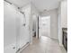 Bright bathroom with glass shower, tiled floors, granite vanity, and views into the bedroom area at 9505 Lemon Drop Loop, Ruskin, FL 33573
