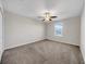 Light-filled bedroom features plush carpeting, a ceiling fan, and a window with blinds for natural light at 9505 Lemon Drop Loop, Ruskin, FL 33573