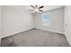Bright bedroom featuring a ceiling fan, neutral walls, plush carpeting, and a window offering natural light at 9505 Lemon Drop Loop, Ruskin, FL 33573